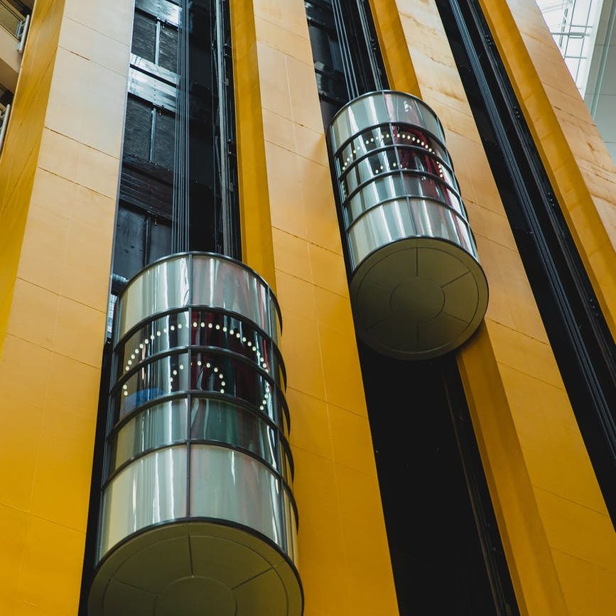 modern geometric building with moving elevators